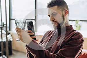 Young man taking photo on mobile phone