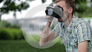 Young Man Taking Pictures At A Professional Digital Slr Camera