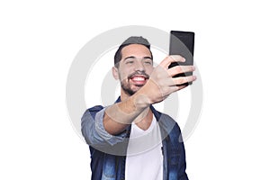 Young man taking a selfie with his smartphone.