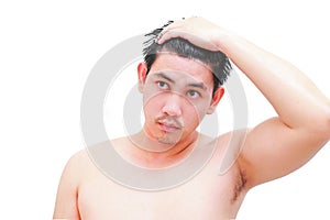 Young man taking a shower and standing under flowing water in bathroom