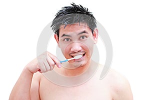 Young man taking a shower and standing under flowing water in bathroom