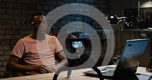 Young man talking on camera in a garage