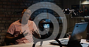 Young man talking on camera in a garage