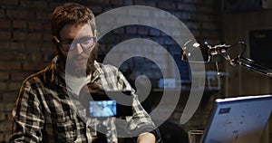 Young man talking on camera in a workshop