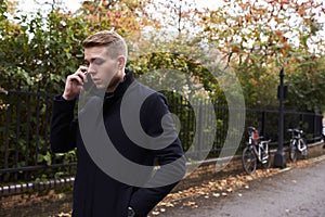 Young Man Talking On Mobile Phone In Oxford Street photo