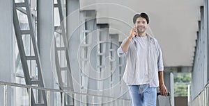 Young man talking on phone after arrival to airport