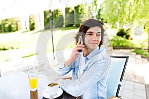 Young man talking on phone while standing outdoor