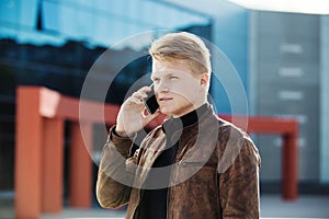 Young man talking on the phone, using smartphone, making a call.