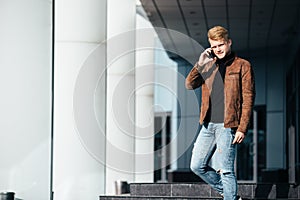 Young man talking on the phone, using smartphone, making a call.