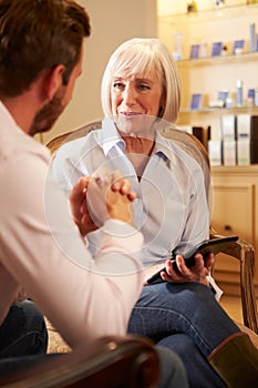 Young Man Talking To Counsellor Using Digital Tablet