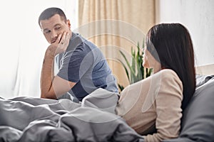 young man talking to upset asian