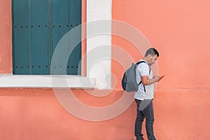 Young Man Talking On And Using His Cellphone