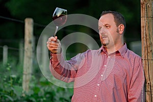 Young man is tasting red wine