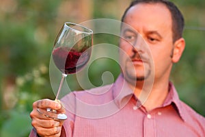 Young man is tasting red wine