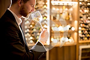 Young man tasting white wine