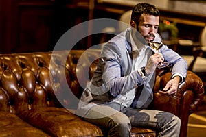 Young man tasting white wine