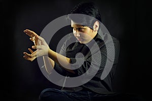 Young man teenager portrait hands focusing