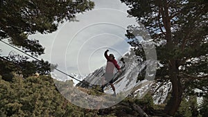 A young man teeters on a slackline in the mountains of the north Caucasus. Slackline en background of the mountains