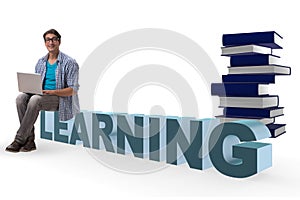 The young man in telelearning concept with laptop and books