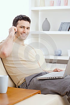 Young man teleworking from home photo