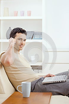 Young man teleworking from home photo