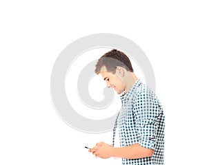 Young man texting chatting messages on phone in plaid shirt isolated on white. Copy space. Mock up.