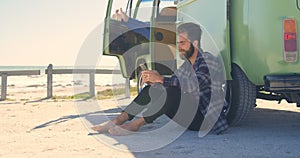 Young man texting on mobile phone near van 4k