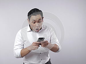 Young Man Texting Reading Chatting on His Phone Surprised Gesture