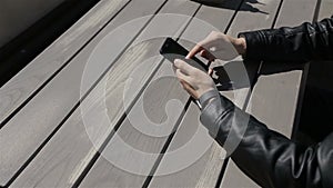 Young man texting on smartphone in cafe.