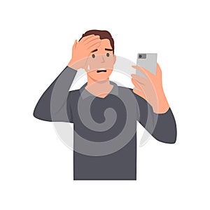 Young man texting using smart phone, stressed with hand on head