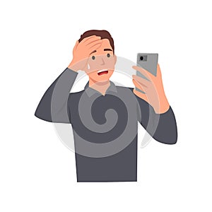 Young man texting using smart phone, stressed with hand on head