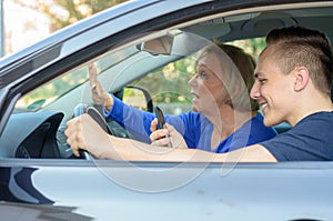 Young man texting at the wheel of a car