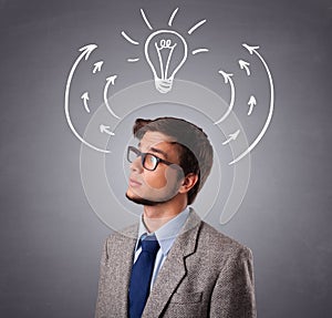 Young man thinking with arrows and light bulb overhead