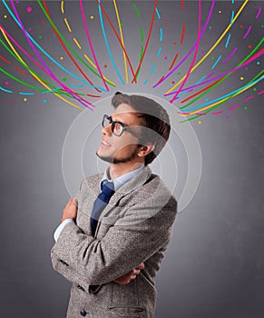 Young man thinking wiht colorful abstract lines overhead