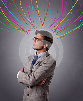 Young man thinking wiht colorful abstract lines overhead