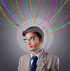 Young man thinking wiht colorful abstract lines overhead