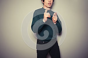 Young man thinks he is cool and is gesturing with his hands