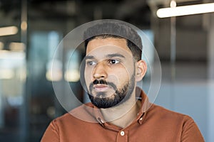 Young man with thoughtful expression looking away