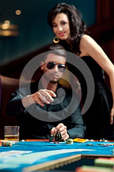 Young man throwing poker chips