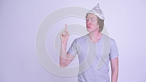 Young man with tinfoil hat thinking and pointing up