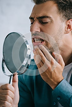 young man with toothache looking