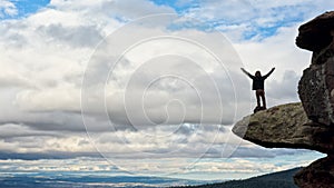 Young man on top of a cliff