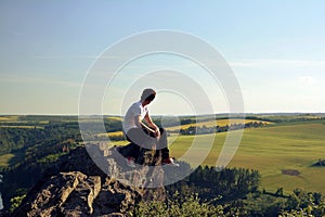 Young man on top of rock