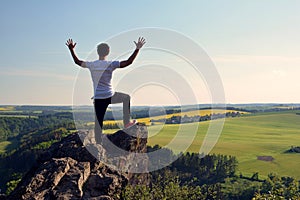 Young man on top of rock