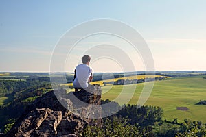 Young man on top of rock
