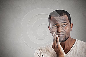 Young man touching face having really bad pain tooth ache