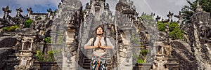 Young man tourist on background ofThree stone ladders in beautiful Pura Lempuyang Luhur temple. Summer landscape with