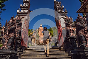 Young man tourist in budhist temple Brahma Vihara Arama Banjar Bali, Indonesia