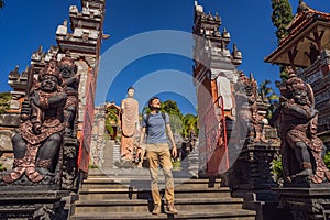 Young man tourist in budhist temple Brahma Vihara Arama Banjar Bali, Indonesia