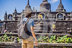 Young man tourist in budhist temple Brahma Vihara Arama Banjar Bali, Indonesia